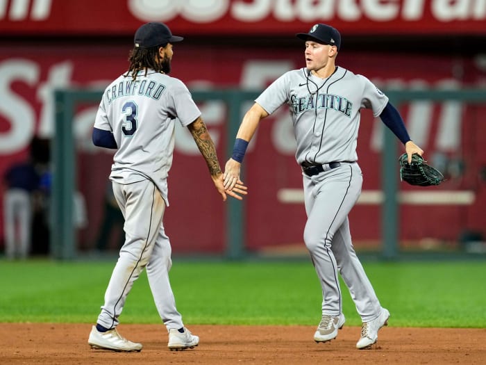 Sep 17, 2021; Kansas City, Missouri, USA; Seattle Mariners center fielder Jarred Kelenic (right) celebrates with shortstop J.P. Crawford (3) after defeating the Kansas City Royals at Kauffman Stadium.